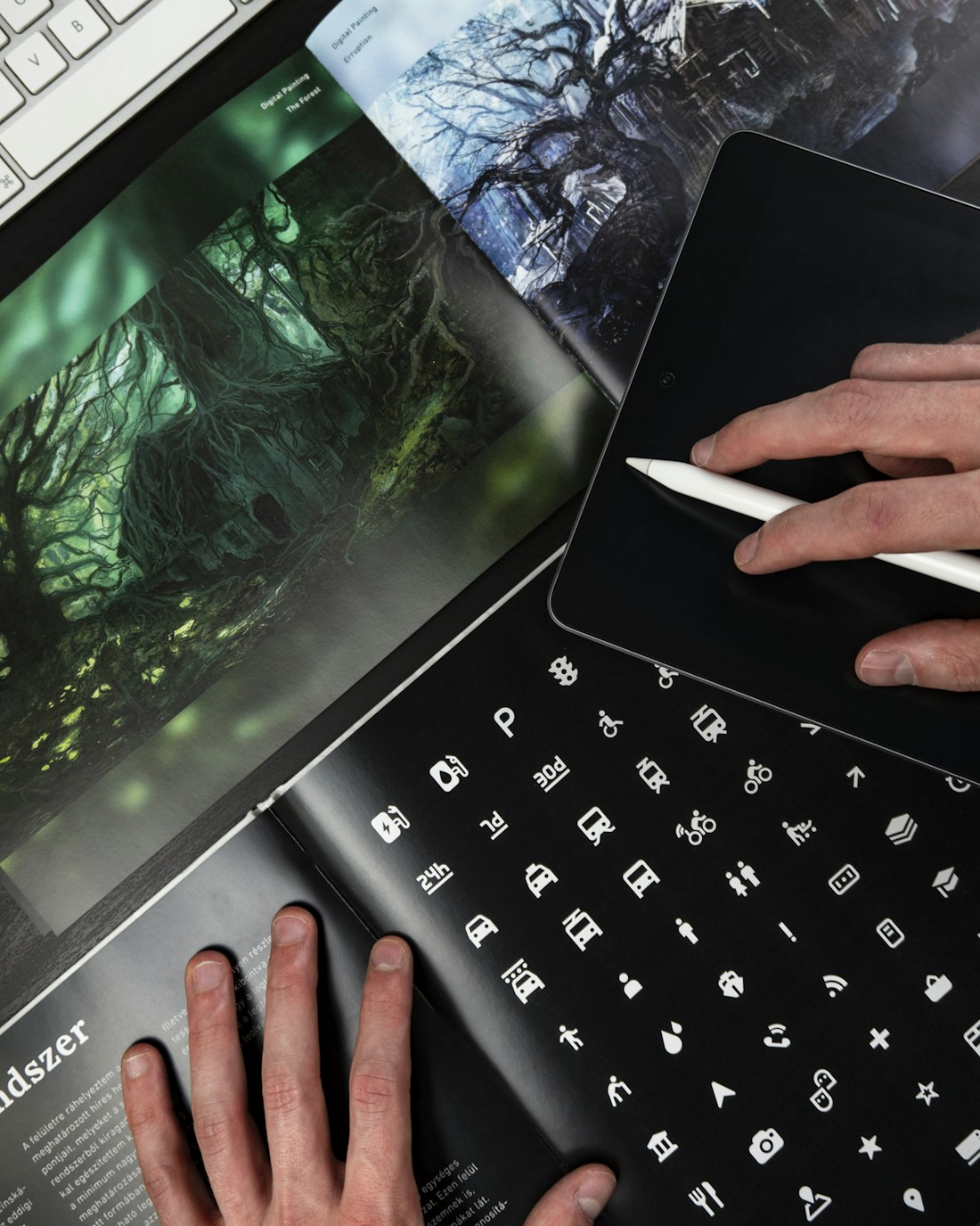 Designer working with paper layouts and a color palette on a desk