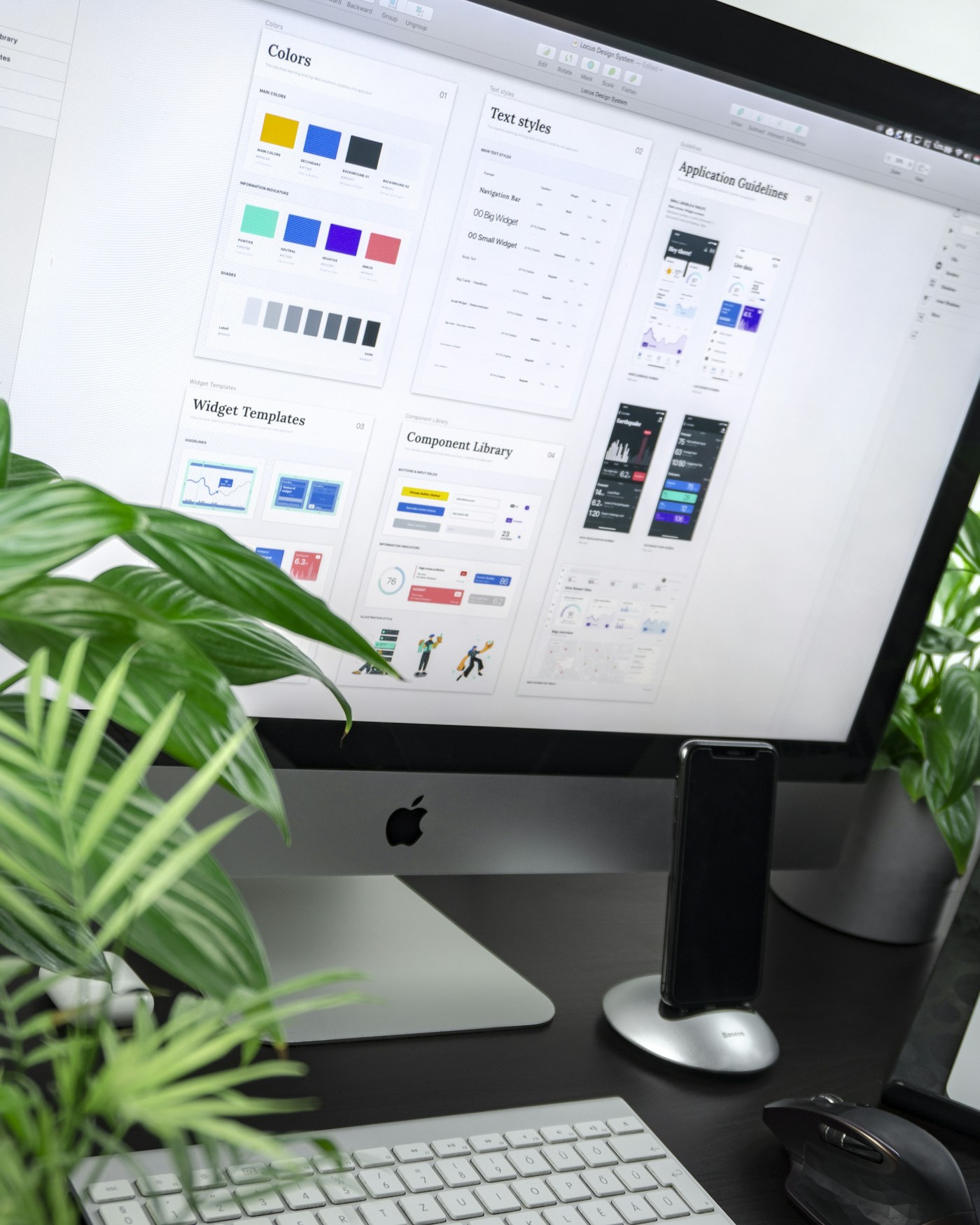 Open sketchbook, typography samples and design tools on a studio table